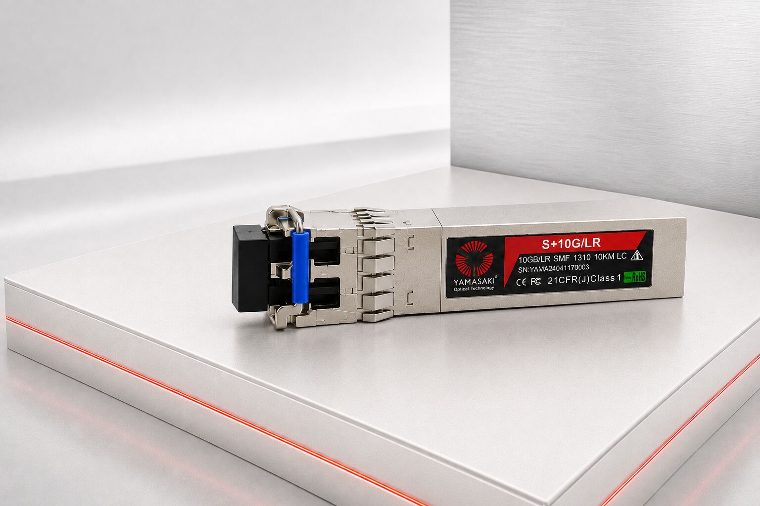 Yamasaki 10G SFP+ Transceiver with blue latch displayed on a pearl-white illuminated platform