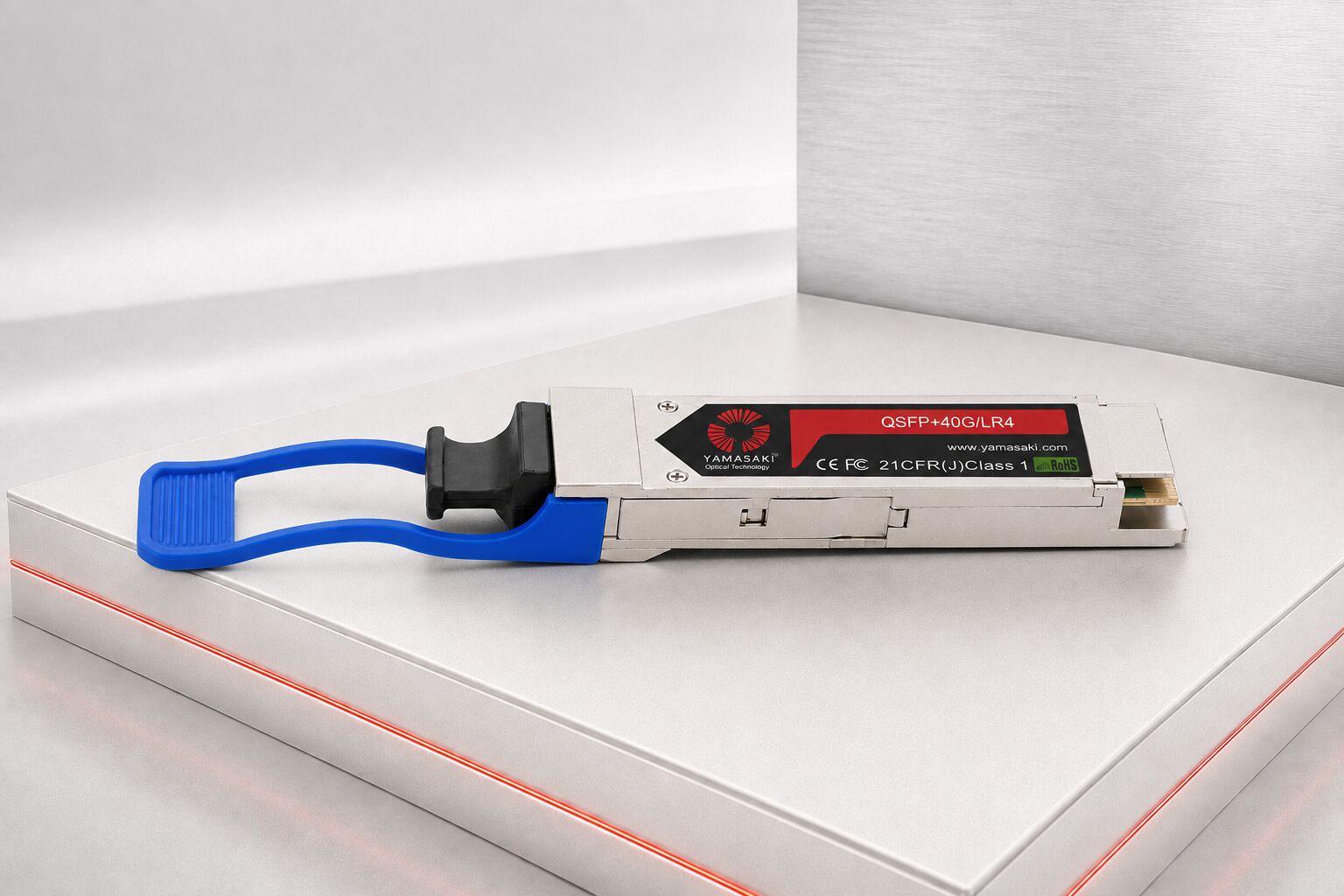 40G QSFP+ Transceiver with blue pull-tab displayed on a silver presentation platform